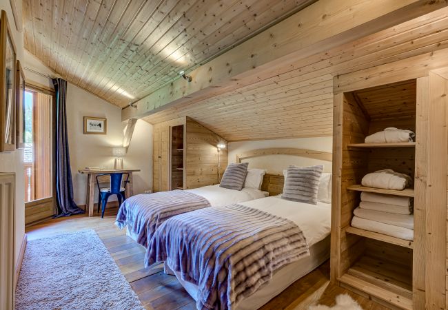 Bedroom 3, flexible double or twin room with shared balcony Bedroom 3 of Chalet Sanaz is a flexible double or twin room with a shared balcony
