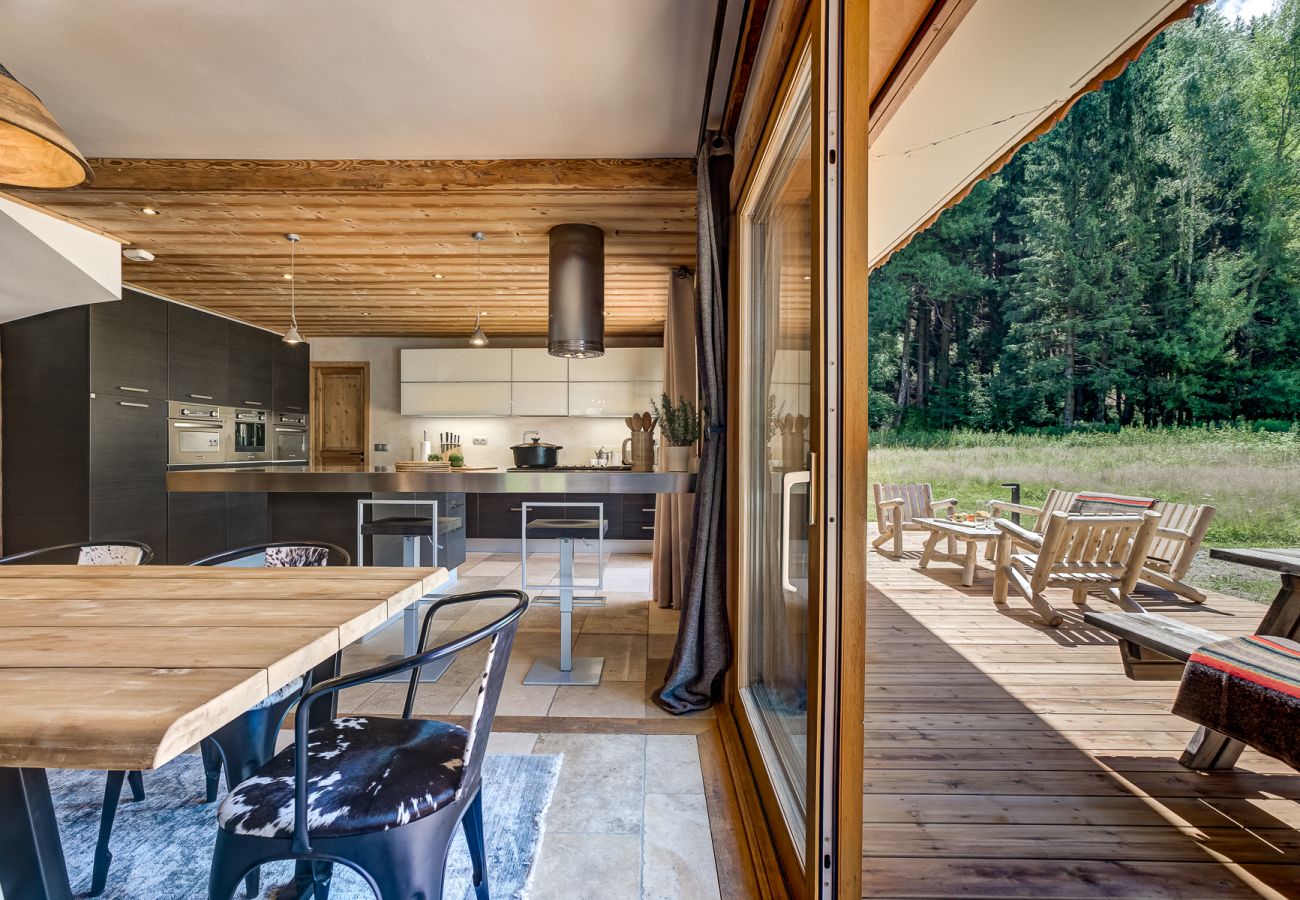 Two sets of glass doors from living area onto deck  Chalet Sanaz has two sets of glass doors from living area onto deck