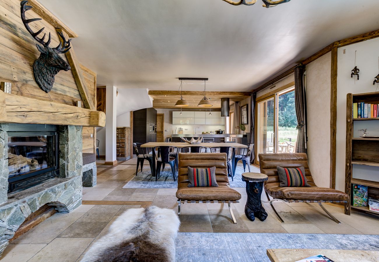 Open plan living area with log burner        Chalet Sanaz has an open plan living area with a log burner